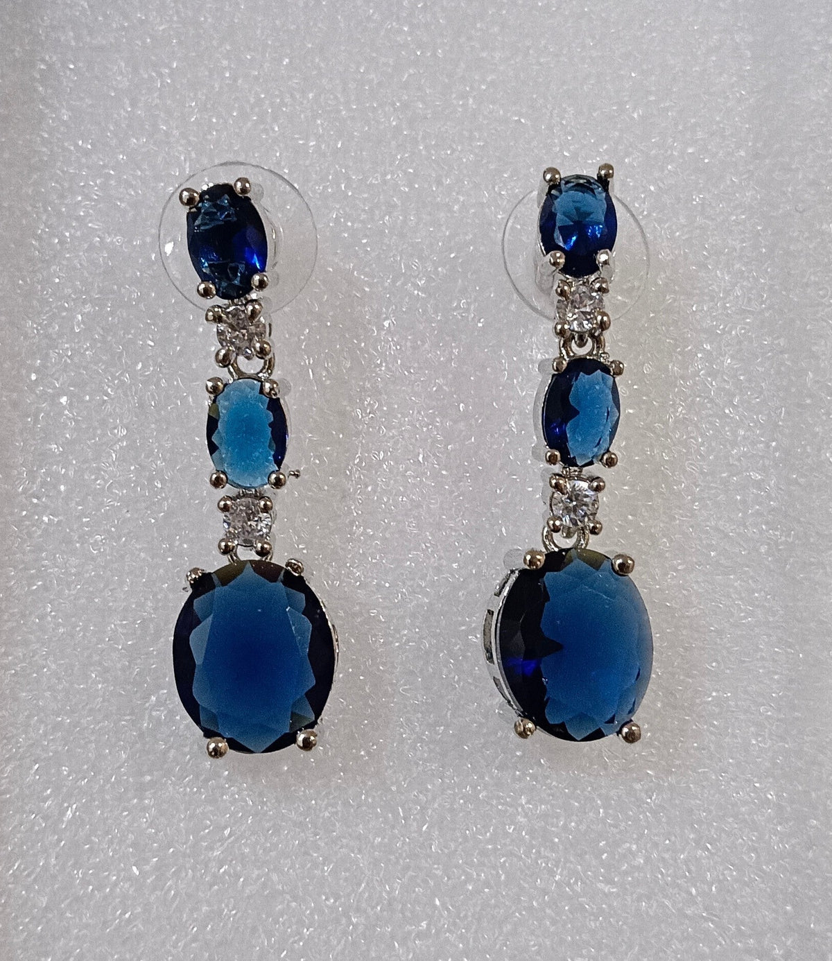 Blue Drop Shaped American Diamond Triple Stone Dangler Earrings